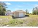 View of detached garage in backyard with surrounding landscaping at 9055 Atlas Dr, St Cloud, FL 34773