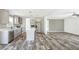 Spacious kitchen with an island, stainless steel appliances, gray cabinets, and modern flooring throughout the open-concept layout at 9055 Atlas Dr, St Cloud, FL 34773