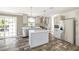 Well-lit kitchen with stainless steel appliances, gray cabinetry, island, and modern pendant lighting at 9055 Atlas Dr, St Cloud, FL 34773
