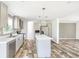 Bright, open kitchen features stainless appliances, gray cabinets, and a center island at 9055 Atlas Dr, St Cloud, FL 34773