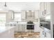 Modern kitchen with stainless appliances, gray cabinetry, quartz countertops and stylish pendant lighting at 9055 Atlas Dr, St Cloud, FL 34773