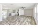 Bright and airy living room open to modern kitchen with hardwood floors at 9055 Atlas Dr, St Cloud, FL 34773