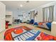 Large bedroom featuring a twin bed, bunk beds, and a video game table and seating at 9084 Sommerset Hills Dr, Davenport, FL 33896