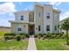 Contemporary two-story home boasts a stone accent wall and well-maintained landscaping at 9084 Sommerset Hills Dr, Davenport, FL 33896