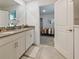 Bathroom with double vanity with gray countertop and white cabinets, and neutral walls at 9084 Sommerset Hills Dr, Davenport, FL 33896