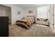 Bedroom with soft carpet, neutral walls, and a comfortable seating area near sun-filled windows at 9084 Sommerset Hills Dr, Davenport, FL 33896