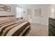 Bedroom with plush bed and chair, white walls, and access to bathroom at 9084 Sommerset Hills Dr, Davenport, FL 33896