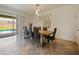 Elegant dining area with modern decor, ample seating, and a seamless transition to the outdoor pool area through sliding glass doors at 9084 Sommerset Hills Dr, Davenport, FL 33896