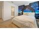 Bedroom featuring a queen bed, space themed wall decor, and an attached bathroom at 9084 Sommerset Hills Dr, Davenport, FL 33896