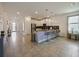 Modern kitchen featuring bar seating, stainless appliances, tile flooring, and abundant natural light at 9084 Sommerset Hills Dr, Davenport, FL 33896