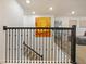 Upstairs hallway has iron railing, modern art and neutral carpeting for an airy, spacious feel at 9084 Sommerset Hills Dr, Davenport, FL 33896
