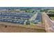 An aerial view of a well-planned community with pools, manicured lawns, and a scenic road nearby at 9084 Sommerset Hills Dr, Davenport, FL 33896