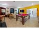 Entertaining game room with a pool table, foosball, and a large screen television for leisure at 9084 Sommerset Hills Dr, Davenport, FL 33896