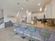 Beautiful kitchen with stainless steel appliances, white cabinetry, and a stylish countertop bar with seating at 9084 Sommerset Hills Dr, Davenport, FL 33896