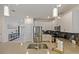 Modern kitchen featuring stainless steel appliances, sleek countertops, and a convenient center island with a sink at 9084 Sommerset Hills Dr, Davenport, FL 33896