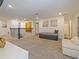 Open loft with neutral carpet and white walls is a flexible space for relaxing and entertaining at 9084 Sommerset Hills Dr, Davenport, FL 33896