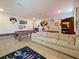 Spacious game room featuring a pool table, foosball table, comfortable seating, and playful decor at 9084 Sommerset Hills Dr, Davenport, FL 33896