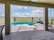 Inviting screened pool with a spa and deck chairs, surrounded by a well-maintained yard and privacy fence at 9084 Sommerset Hills Dr, Davenport, FL 33896