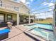 Inviting screened-in pool and patio with a spa, ideal for relaxing and enjoying the Florida sunshine at 9084 Sommerset Hills Dr, Davenport, FL 33896