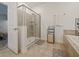 Bathroom featuring a glass-enclosed shower, linen storage, and neutral finishes for a clean, modern look at 9084 Sommerset Hills Dr, Davenport, FL 33896
