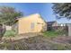 Backyard showing the back of the home with siding and grass at 9447 Dearmont Ave, Orlando, FL 32825