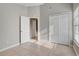 Bedroom features tile floors, a window, closet, and entrance to another room at 9447 Dearmont Ave, Orlando, FL 32825