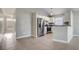 An open kitchen with stainless steel appliances and white cabinets; tile floor extends into adjacent space at 9447 Dearmont Ave, Orlando, FL 32825
