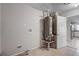 A utility room featuring a water heater, tile flooring and access to other areas of the house at 9447 Dearmont Ave, Orlando, FL 32825