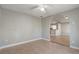 An open living room featuring neutral paint and tile flooring, connected to the kitchen by an arched opening at 9447 Dearmont Ave, Orlando, FL 32825