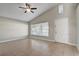 Bright, open living room featuring tile flooring, high ceilings, and a ceiling fan at 9447 Dearmont Ave, Orlando, FL 32825