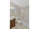 Bathroom features tiled walls, a vanity with storage, and a shower with sliding glass doors at 1001 Dora Ave, Tavares, FL 32778