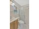 Bathroom featuring tiled walls, vanity with storage, and a shower with sliding glass doors at 1001 Dora Ave, Tavares, FL 32778