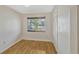 Bright bedroom with wood floors, a window with blinds, and a closet at 1001 Dora Ave, Tavares, FL 32778