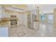 Modern kitchen with stainless steel appliances, white cabinets, and granite countertops at 1001 Dora Ave, Tavares, FL 32778