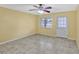 Bright living room featuring tile floors, a ceiling fan, and a door leading to the outside at 1001 Dora Ave, Tavares, FL 32778