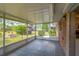 Enclosed patio features tiled floors, a screened enclosure, and views of the landscaped backyard at 1001 Dora Ave, Tavares, FL 32778