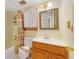 Cozy bathroom features a vanity, framed mirror, and a shower/tub combo at 1048 Plantation Dr # 12, Kissimmee, FL 34741