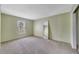 Spacious bedroom featuring neutral paint, carpet, and a window for natural light at 1048 Plantation Dr # 12, Kissimmee, FL 34741