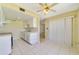 Efficient kitchen layout with white cabinets, stainless steel sink, and dining area at 1048 Plantation Dr # 12, Kissimmee, FL 34741