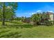 Lush backyard with mature trees offering privacy, highlighted by view of screened-in lanai at 1065 Cavan Dr, Apopka, FL 32703