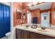 Bathroom featuring double sinks with dark wood vanity, wainscoting, and a blue shower curtain at 1065 Cavan Dr, Apopka, FL 32703