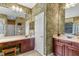 Bathroom with palm tree wallpaper, dual sinks, and a vanity area, offering a unique and tropical aesthetic at 1065 Cavan Dr, Apopka, FL 32703