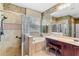 Tiled bathroom featuring a glass shower, soaking tub, and vanity with a makeup area at 1065 Cavan Dr, Apopka, FL 32703