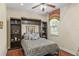 Comfortable bedroom featuring a Murphy bed, bedside shelving, and a window with valance at 1065 Cavan Dr, Apopka, FL 32703