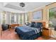 Spacious bedroom with a bay window, desk area, and stylish furniture at 1065 Cavan Dr, Apopka, FL 32703