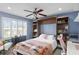 Charming bedroom with a built-in Murphy bed, shelving, a ceiling fan, and bright natural light at 1065 Cavan Dr, Apopka, FL 32703