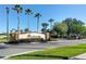 Breckenridge community entrance featuring a landscaped brick sign and palm trees against a clear blue sky at 1065 Cavan Dr, Apopka, FL 32703