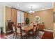 Elegant dining room with hardwood floors, a chandelier, and seating for eight at 1065 Cavan Dr, Apopka, FL 32703