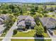 Beautiful home with manicured lawn, stone accents, and a long driveway with mature landscaping at 1065 Cavan Dr, Apopka, FL 32703