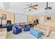 Large game room featuring a projector screen, various seating options, and ample space for recreational activities at 1065 Cavan Dr, Apopka, FL 32703